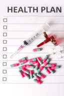 Health plan form with a syringe and capsules