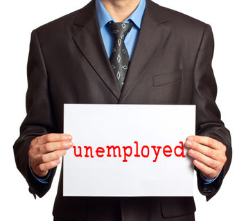 A man holding an unemployed sign