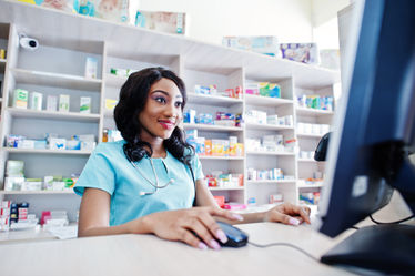 Pharmacist working on a computer at a pharmacy