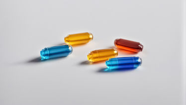Multi-colored capsules displaying with a gray background
