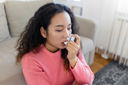 Woman using an asthma inhaler