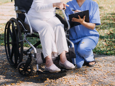 Caregiver doctor serve physical therapy for older elderly patient to exercise and practice walking on walker