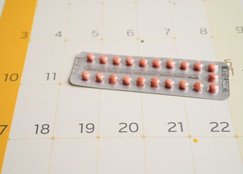 Some pills on a calendar