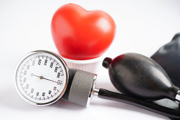 Blood pressure meter isolated on white background with a model of a heart