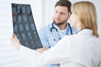 Doctors looking at brain scans