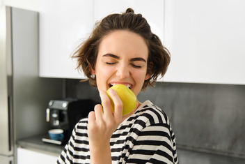 Woman eating an apple