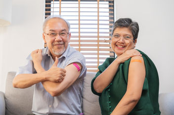 Elderly couple receiving vaccinations