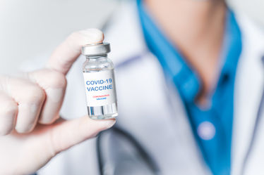 Doctor holding COVID-19 vaccine