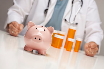 Doctor behind pharmacy counter with piggy bank