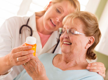 Female physician explaining prescription to senior adult woman