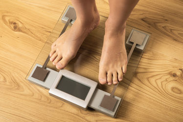 A female feet on the modern digital weighing scale