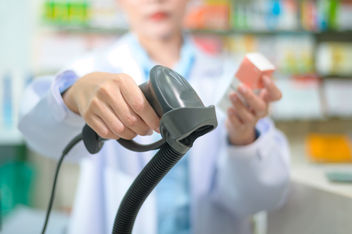 Pharmacist scanning box at point of sale