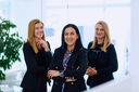 A group of businesswomen in a modern office setting