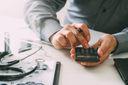 A doctor using a calculator to show cost savings