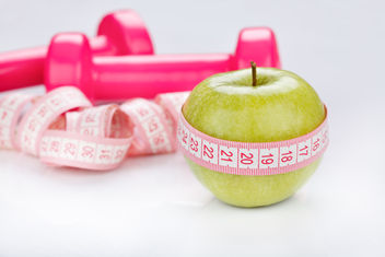 Weights and green apple to promote healthy living