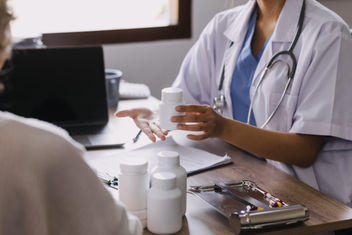 Close up of physician discussing with an older patient during visit