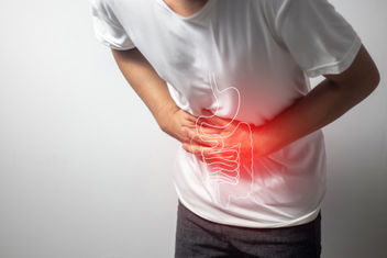 A man having abdominal pain on white background