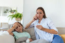 Mother taking the temperature of sick child