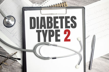 A notebook with text Diabetes Type 2 with pen and stethoscope