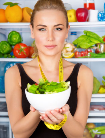 Woman holding a bowl of healthy salad