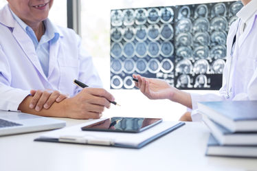 A doctor discussing MRI brain scans with his patient