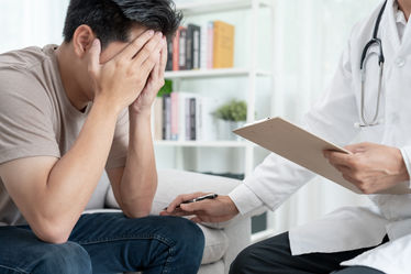  A doctor encourages and empathizes for patient suffering from depression
