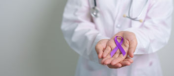 A doctor holding a purple ribbon representing epilepsy