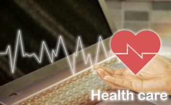 A heart icon resting on a hand with Healthcare displayed underneath