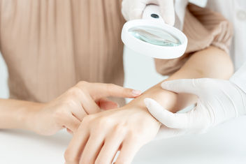 Young woman with itchy skin being evaluated by a doctor