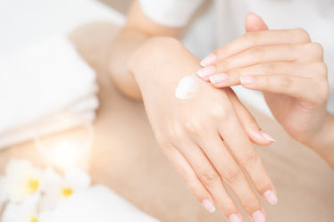 Woman applying moisturizing hand cream