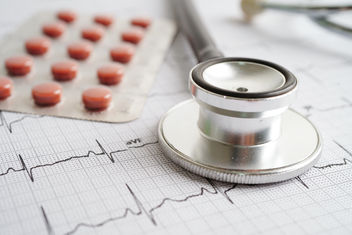 Stethoscope on electrocardiogram with drug, heart wave, heart attack, cardiogram report