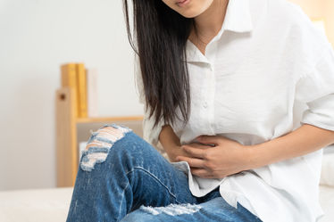 A woman having stomach pain as a result of constipation