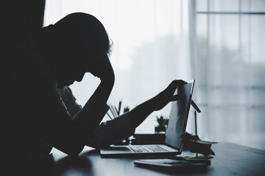 A man looking tired at his office