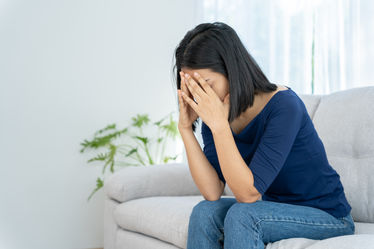 An unhappy woman felling sad about problem and home alone