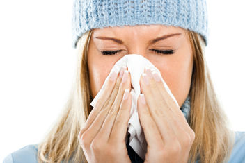 Woman blowing into tissue