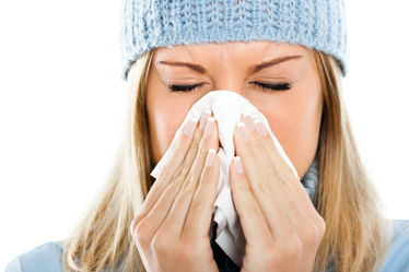 Woman blowing into tissue