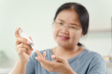 Woman using a lancet to check her blood sugar
