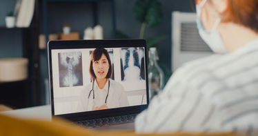 A patient having an online appointment with his physician