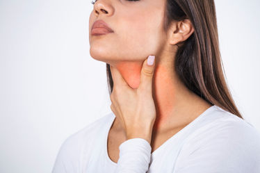 A woman suffering from pain in throat