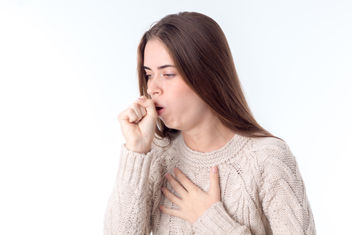 Young girl feeling ill and coughing