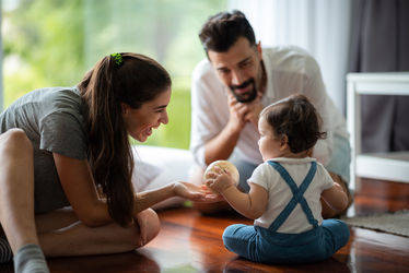 A young mother, father,  and child baby are happy at home