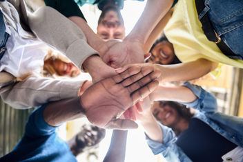 Diverse group of people with hands in