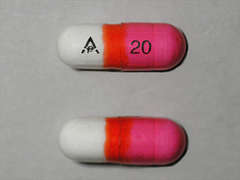 This is a pink oblong Capsule imprinted with logo on the front, 20 on the back, and is manufactured by RICHMOND PHARM.