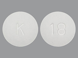 Esto es un Tableta imprimido con K en la parte delantera, 18 en la parte posterior, y es fabricado por None.