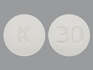 Esto es un Tableta imprimido con K en la parte delantera, 30 en la parte posterior, y es fabricado por None.
