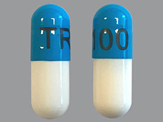 Esto es un Cápsula imprimido con TR100 en la parte delantera, nada en la parte posterior, y es fabricado por None.