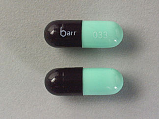 This is a Capsule imprinted with barr on the front, 033 on the back.