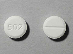 Esto es un Tableta blanco redondo imprimido con 502 en la parte delantera, nada en la parte posterior, y es fabricado por CARACO/SUN PHAR.