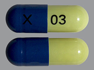This is a Capsule Dr imprinted with X on the front, 03 on the back.