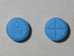 This is a dark blue round Tablet imprinted with E  84 on the front, nothing on the back, and is manufactured by SANDOZ.